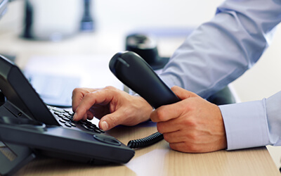 A TotalBC Telephone Technician operating a telephone.