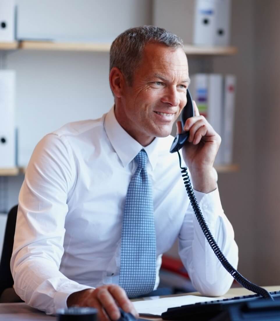 Older man talking on cellphone and smiling