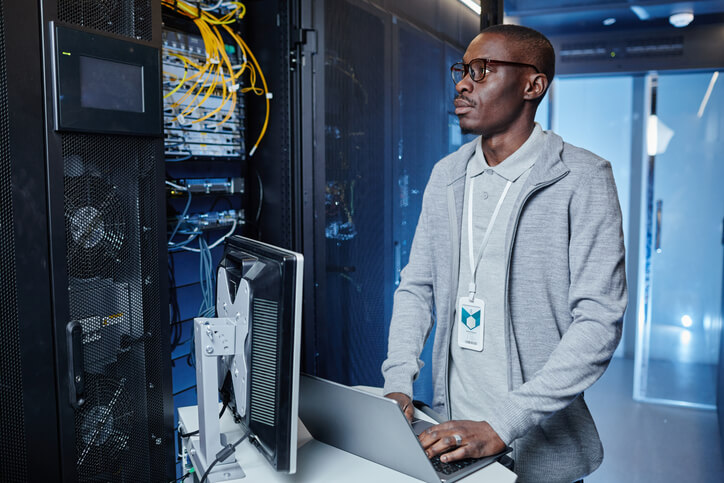 IT technician working in a server room, professional IT support services offered by TotalBC.
